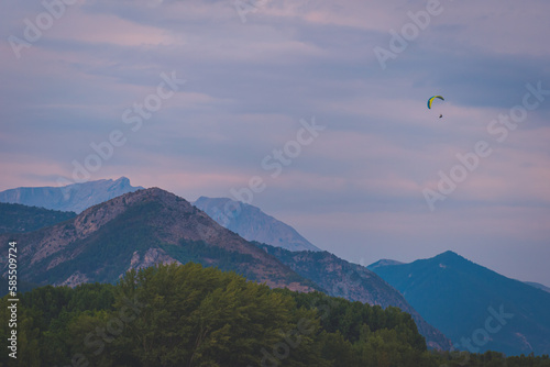 A paraglider in the French Alps during the sunset