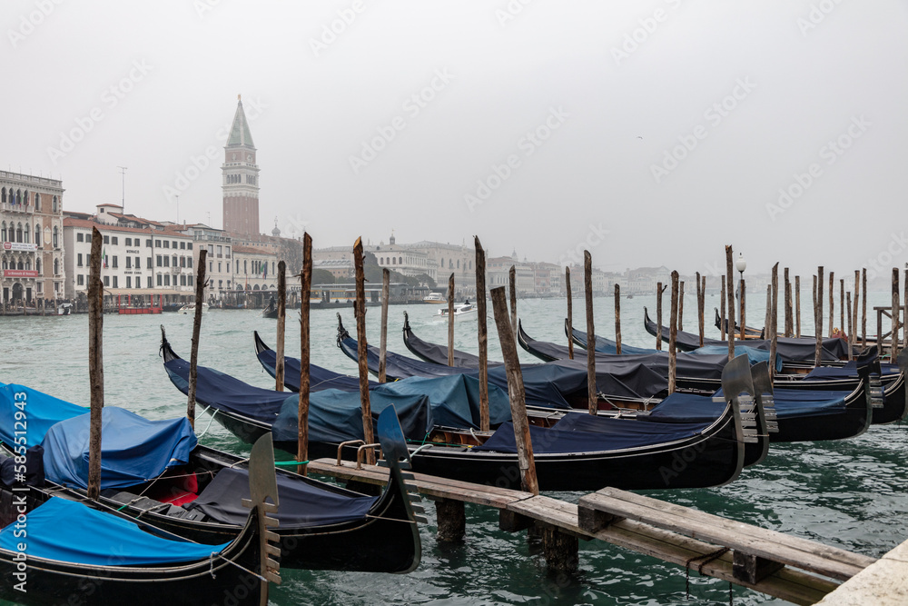 View of Gondolas on the Canal Grande, St. Mark's Square in Venice with bell tower and Palazzo Ducale from Punta della Dogana. 