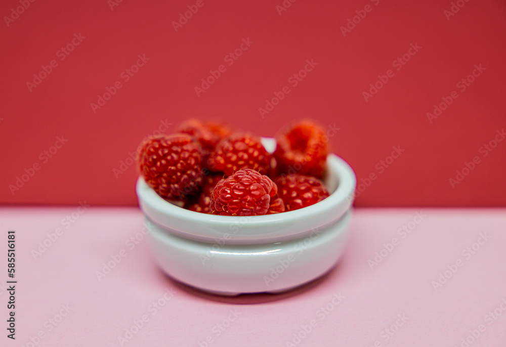 A photo of raspberries in different colors on backgrounds of different colors. A photo of raspberries in different colors on backgrounds of different colors.