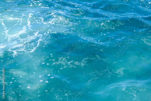 Natural background of blue foaming sea water