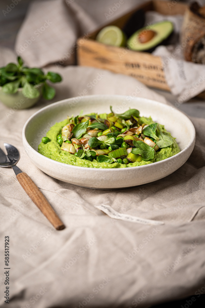 Mashed green peas with leek in a bowl