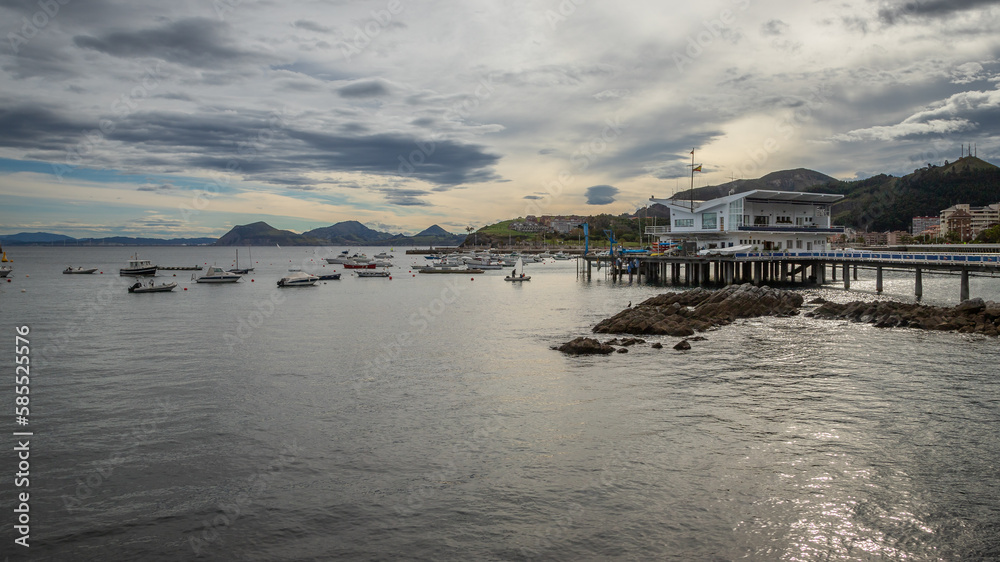 Exposure view of the seaport of Castro Urdiales, namely its Naval Club on a summer day before sunrise, located in the region of Cantabria, Spain.