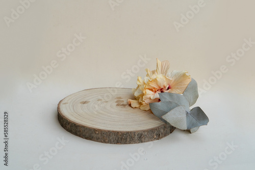 Minimal modern product display podium on neutral background with wooden podium, tropical summer flowers photo