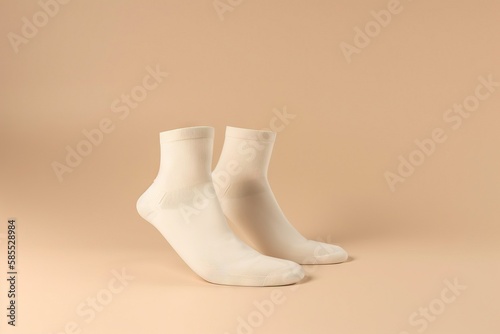  a pair of white socks sitting on top of a beige background with no shoes on it and no socks on the bottom of the socks. generative ai