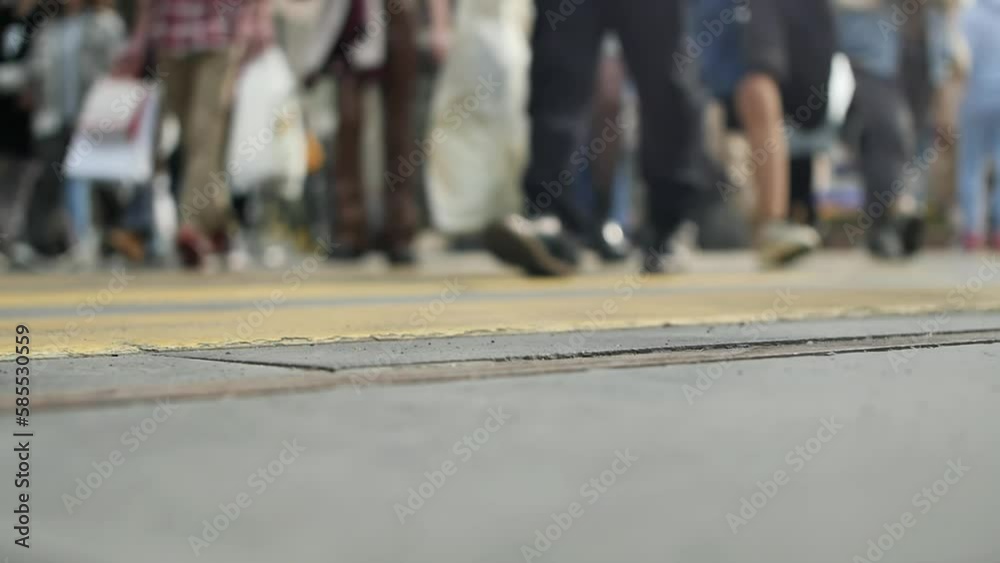 The feet of many people walk across the street at a crosswalk in slow motion and blurry bokeh. Urban traffic of people in an active busy city during rush hour. Social research of population activity The feet of many people walk across the street at a crosswalk in slow motion and blurry bokeh. Urban traffic of people in an active busy city during rush hour. Social research of population activity