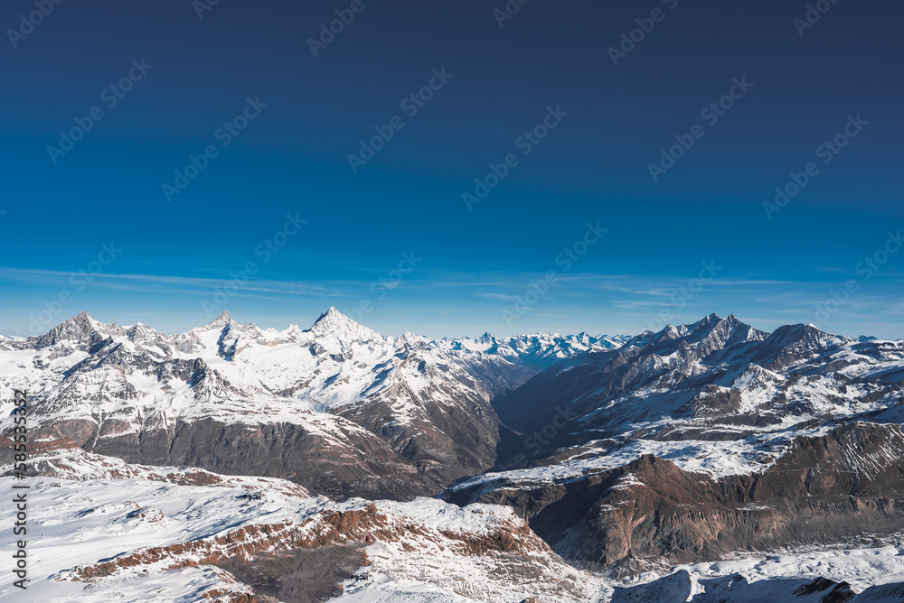 Ski slope and snow covered winter mountains. Matterhorn is a mountain in the Pennine Alps on the border between Switzerland and Italy. Peak of the Matterhorn Glacier Paradise.