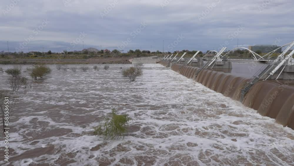 Water rushing over the dam at Tempe Town Lake in Tempe, Arizona with
