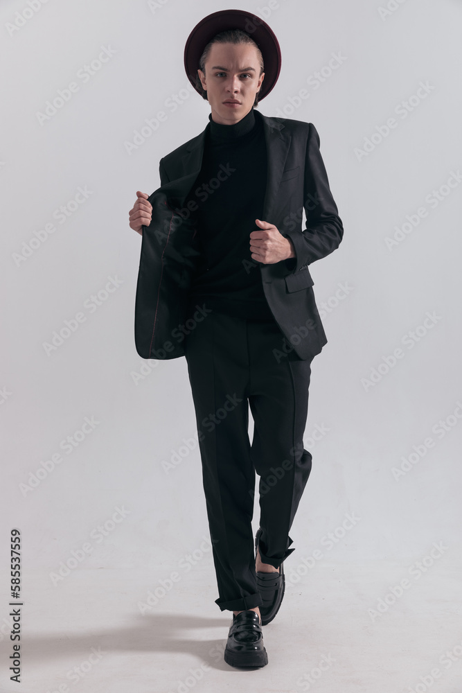 businessman walking towards camera and fixing his jacket businessman walking towards camera and fixing his jacket
