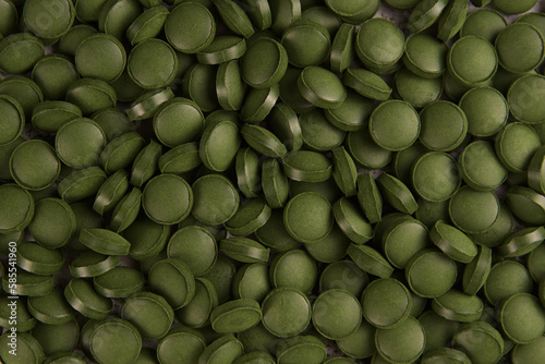 Green tablets of bio chlorella. A health-promoting dietary supplement rich in vitamins. Chlorella vulgaris.