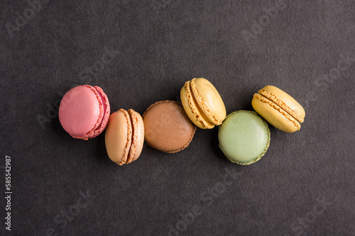 Sweet colorful macarons dessert on a black background photo