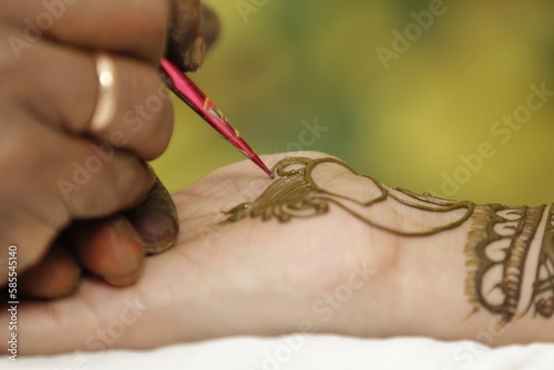 Painting Henna on The Hand.