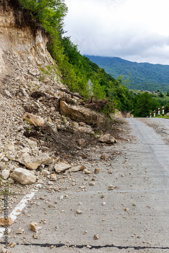 Limestone rockfall and landslide fallen and blocking tarmac road leading to Khvamli Mountain peak in Georgia. photo