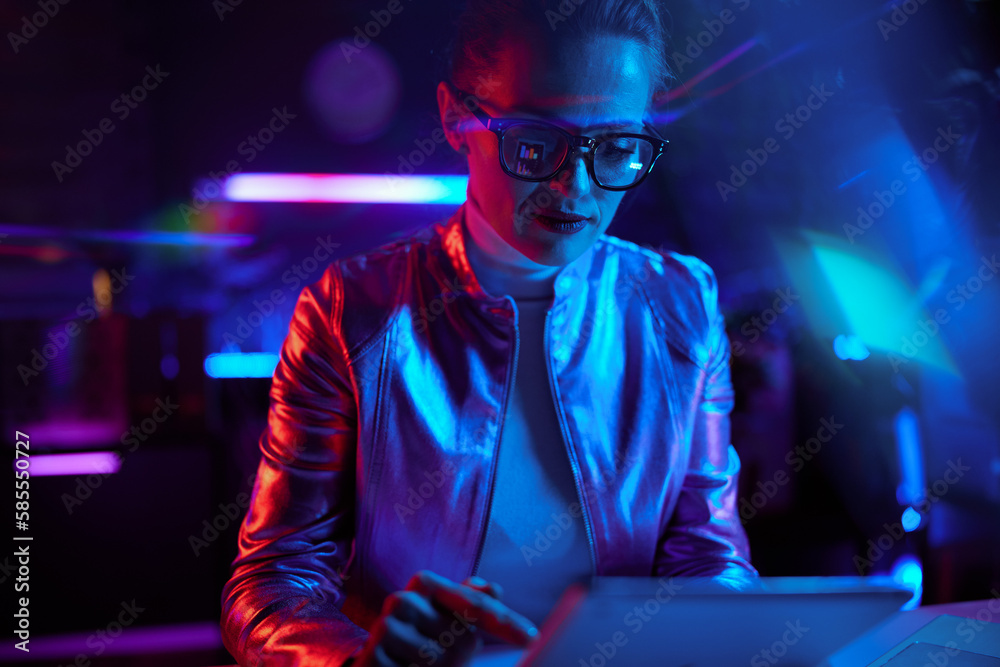 elegant woman in glasses with tablet PC in modern office