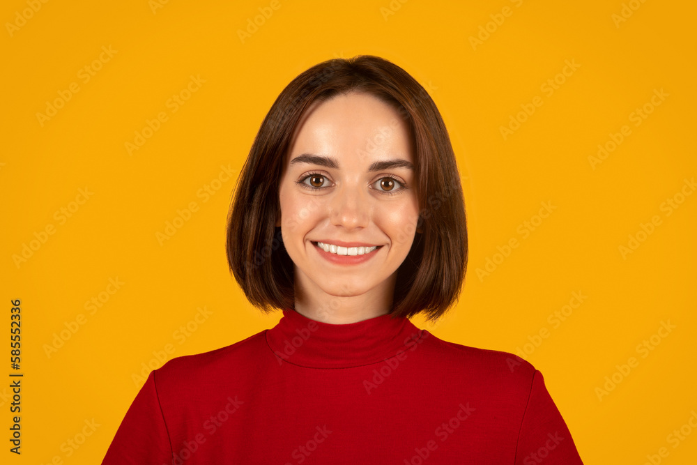 Portrait of cute young brunette woman on orange studio background Portrait of cute young brunette woman on orange studio background