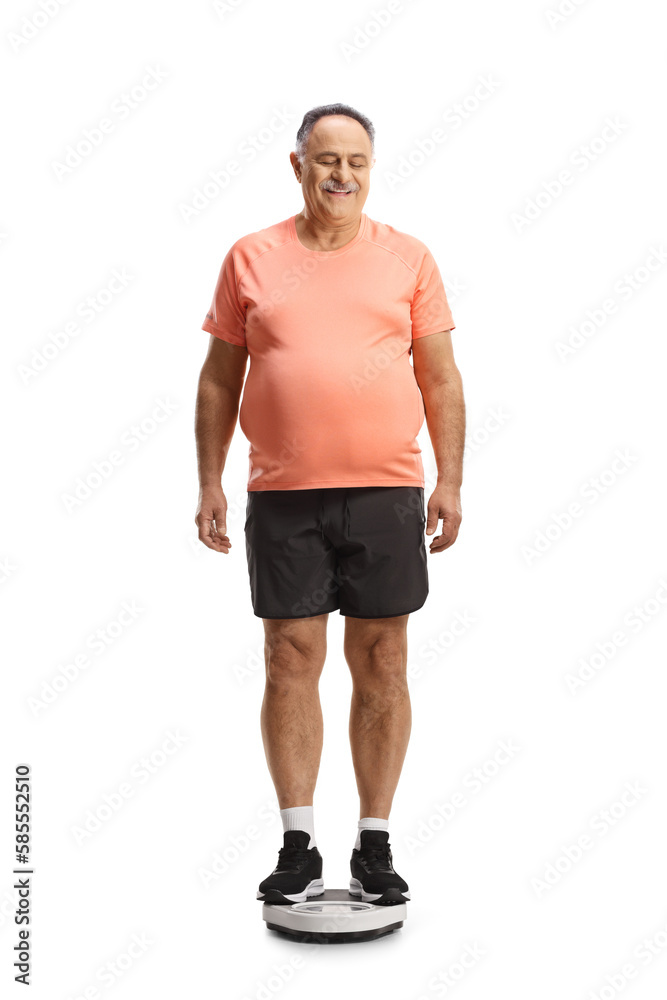 Fototapeta premium Corpulent mature man standing on a weight scale