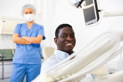 Portrait of satisfied male patient in a dental chair