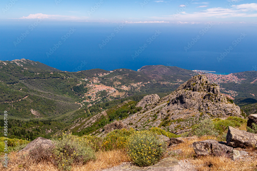 High angle view from summit station of Monte Capanne cable car to mountain village Marciana Alta and bay of Marciana Marina, Island of Elba, Italy