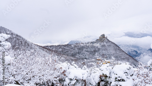 Image of the Ancient/ Abbey of San Michele built on Mount Pirchiriano located at the entrance of the Susa Valley, around the years between 983 and 987 A.D. with an abundant snowfall