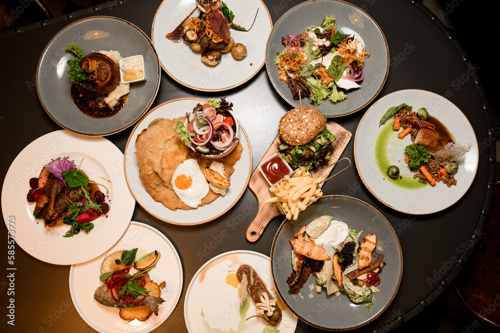 top view of plates with different dishes on table top view of plates with different dishes on table