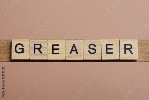 Tablou pe pânză gray word greaser made of wooden square letters on brown background