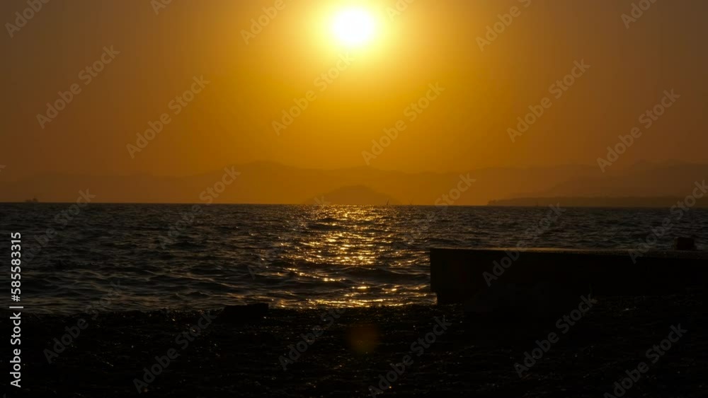 Empty summer bay silhouette in the dusk. A view of empty summer bay silhouette against evening sky with red sun. A concept of nice tropical sandy shore by water. Empty summer bay silhouette in the dusk. A view of empty summer bay silhouette against evening sky with red sun. A concept of nice tropical sandy shore by water.