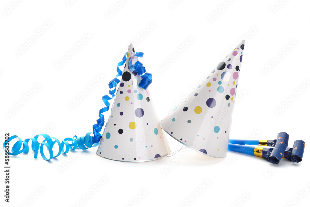 Party hats with serpentine and whistles on white background