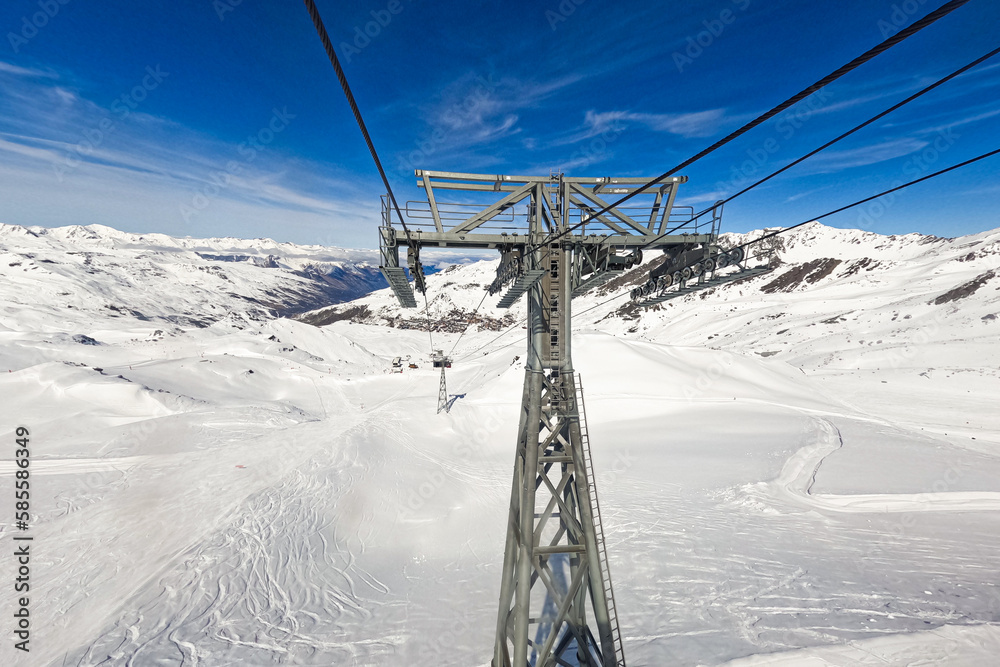 Chairlift post at the top of a snowy mountain above the Val Thorens ski resort in the French Alps Chairlift post at the top of a snowy mountain above the Val Thorens ski resort in the French Alps