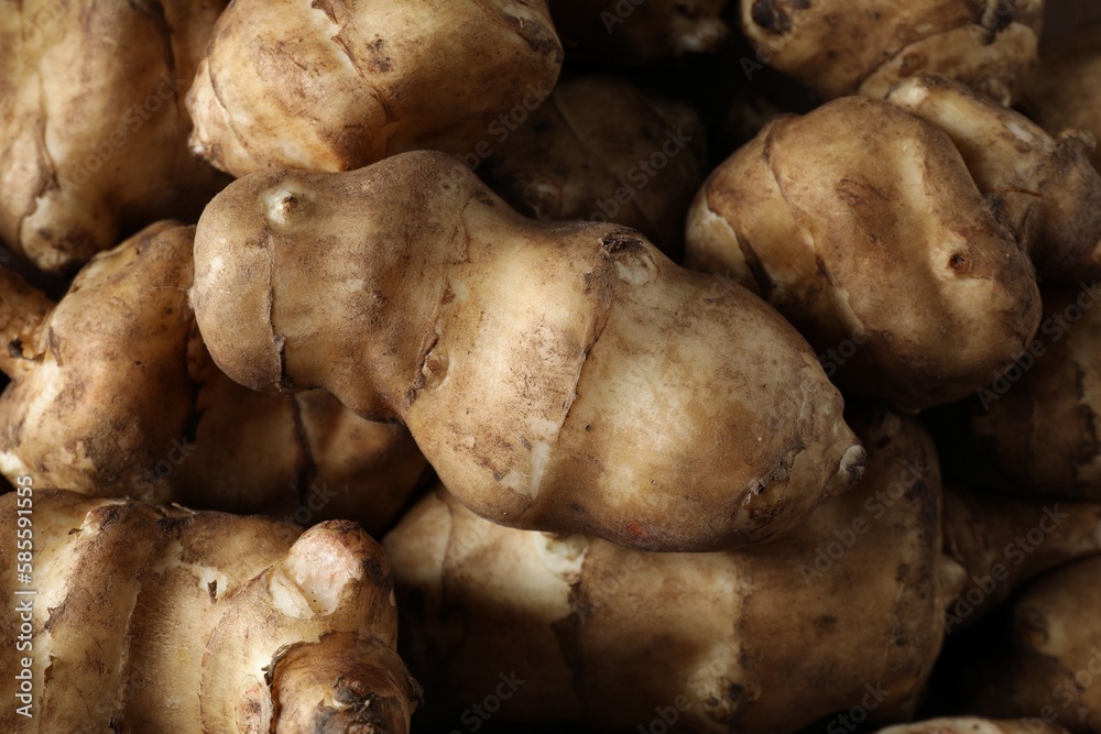 Many fresh Jerusalem artichokes as background, closeup Many fresh Jerusalem artichokes as background, closeup