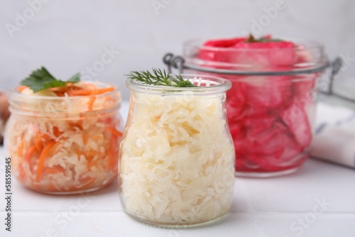 Delicious sauerkraut prepared according to different recipes on white table, closeup