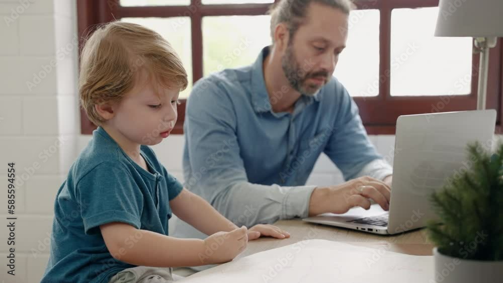 Father sitting at work using tablet while son drawing and painting, family relations concept
Father sitting at work using tablet while son drawing and painting, family relations concept