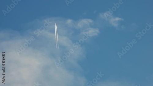 a passenger plane flying through the clouds, Viewed from below in nadir shot.