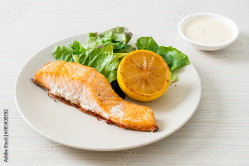 fried salmon steak with lemon and vegetable