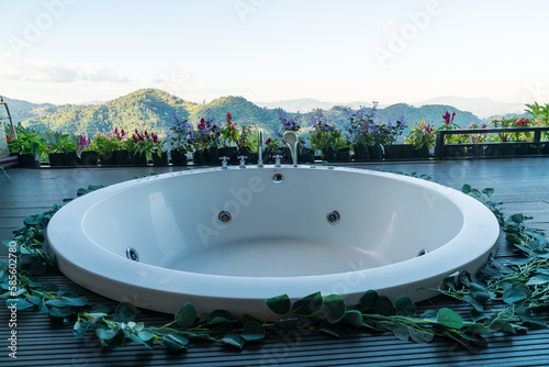bath tub on balcony with mountain hill background © topntp
