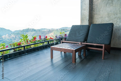 chair on balcony with mountain hill background