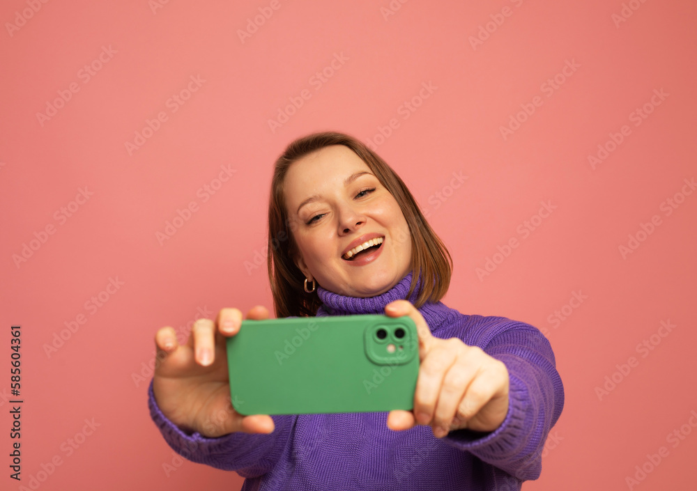 Image of cheerful woman standing isolated over pink background wall talking by mobile phone. Image of cheerful woman standing isolated over pink background wall talking by mobile phone.