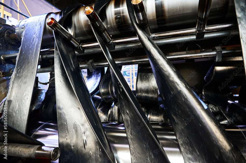 Black rubber ribbons rolled by tool at compound calendering Stock Photo ...