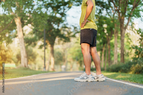 man jogging and walking on the road at morning, adult male in sport shoes running in the park outside. Exercise, wellness, healthy lifestyle and wellbeing concepts