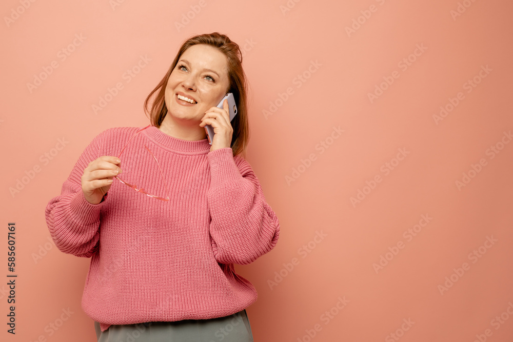 cheerful woman talking on mobile phone over pink background cheerful woman talking on mobile phone over pink background