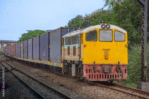 Container-freight train by diesel locomotive on the railway.