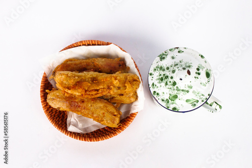 Fried bananas and small vintage cups white with green patterns. isolated on white background