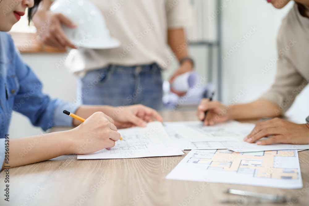Concept of engineering consulting, Engineer team point blueprint of building to discussing together Concept of engineering consulting, Engineer team point blueprint of building to discussing together