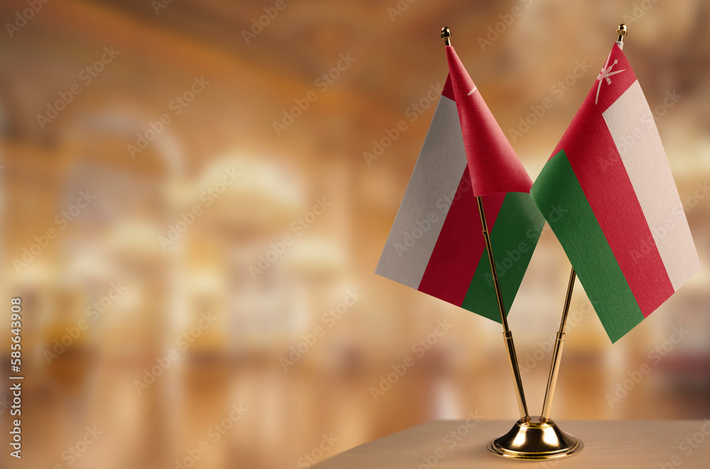 Small flags of the Oman on an abstract blurry background