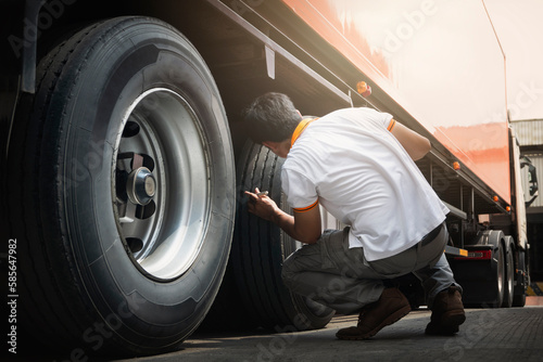 Truck Drivers Checking the Truck's Safety of Truck Wheels Tires. Auto Mechanic. Truck Inspection Safety Driving. 
