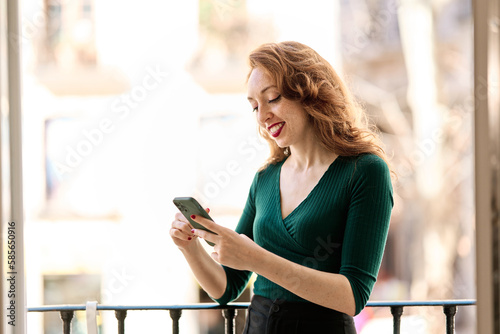 Happy beauty woman using a mobile on a terrace