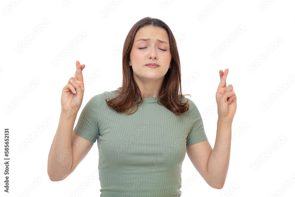 Portrait of twenty year old girl with fingers crossed, concept of wishing for good luck or praying about something, isolated on whitebackground. Young brunette woman posing in studio. Portrait of twenty year old girl with fingers crossed, concept of wishing for good luck or praying about something, isolated on whitebackground. Young brunette woman posing in studio.