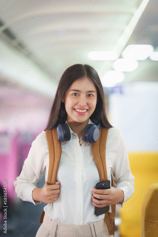 Beautiful Asian traveler woman with backpack when flight is landing. Travel, Airplane concept Beautiful Asian traveler woman with backpack when flight is landing. Travel, Airplane concept