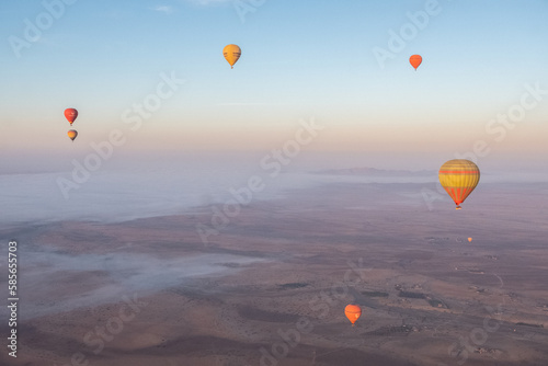 Gorgeous aerial view of hot air balloons flying over the Marrakech desert © Alessandro Vecchi