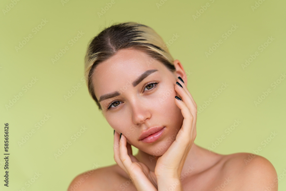 Beauty portrait of young topless woman with bare shoulders on green background with perfect skin and natural makeup Beauty portrait of young topless woman with bare shoulders on green background with perfect skin and natural makeup