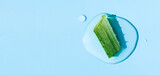banner aloe vera on a light blue background round drops top view with place for text