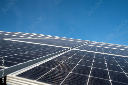 Panels of solar renewed economical batteries on the background of the blue sky.